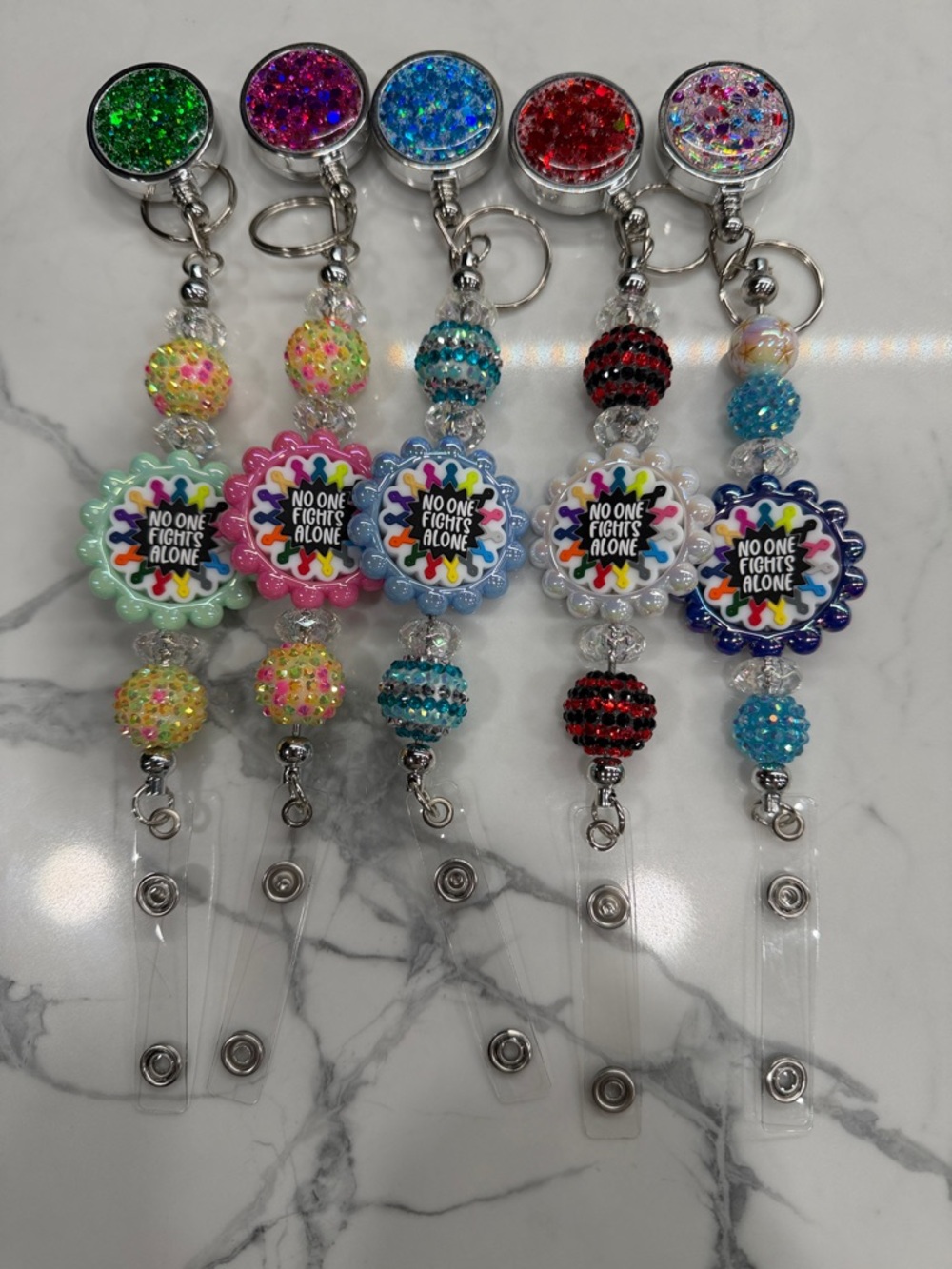 Colorful Beaded 'No One Fights Alone' Badge Reel - Assorted Colors. $5 each!!